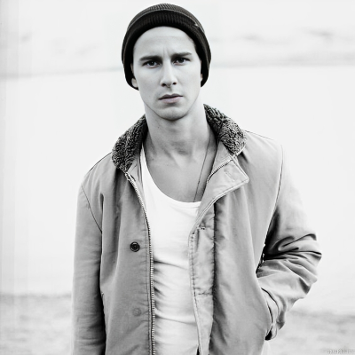 Kelly Blatz taking a picture with a beanie and a jacket on.